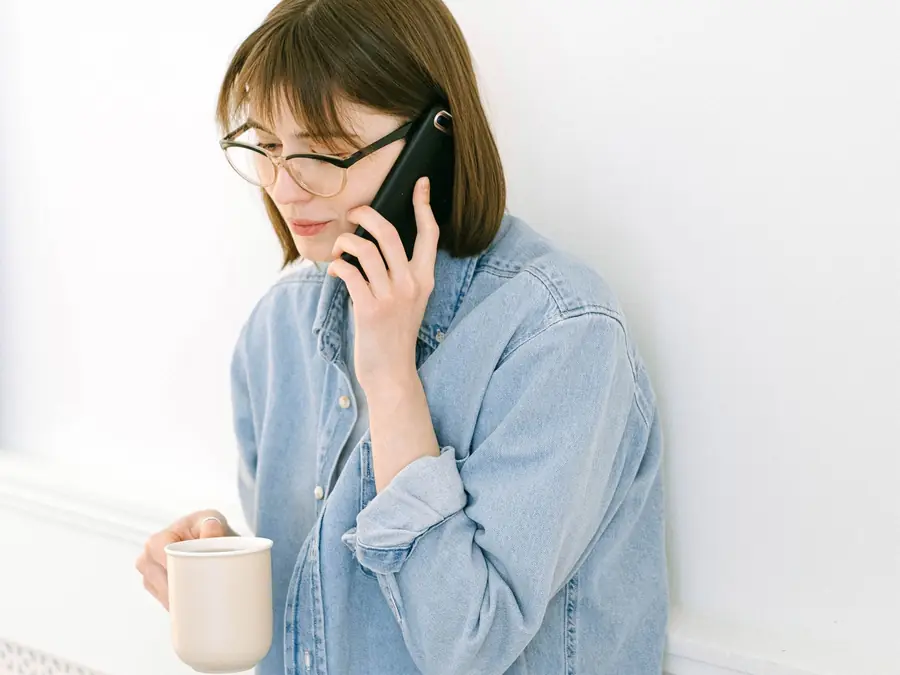 Woman at home talking on her phone