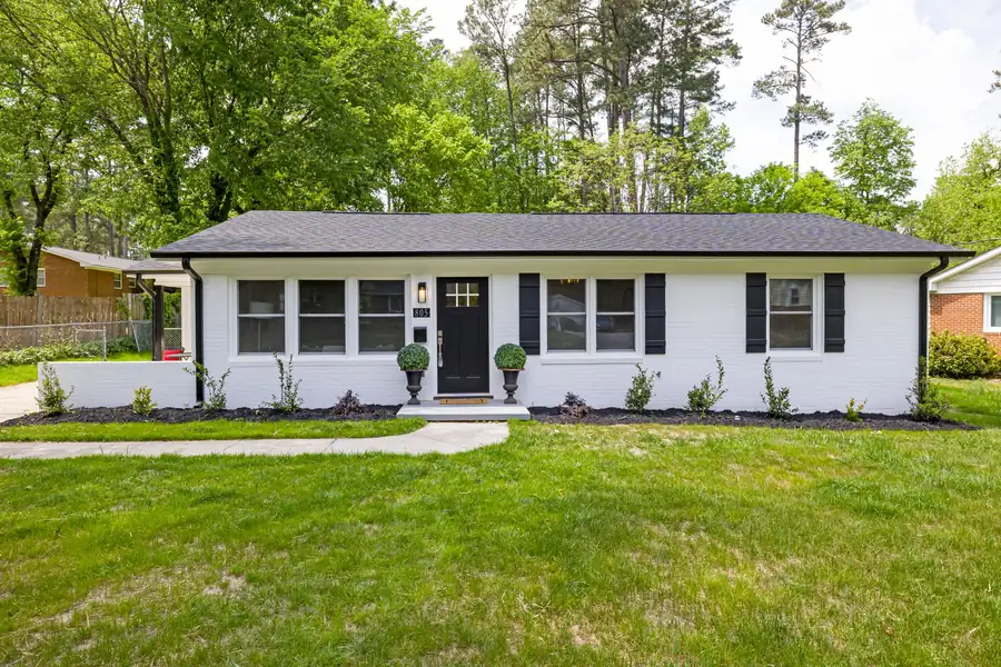 Single story ranch house with a wide front lawn